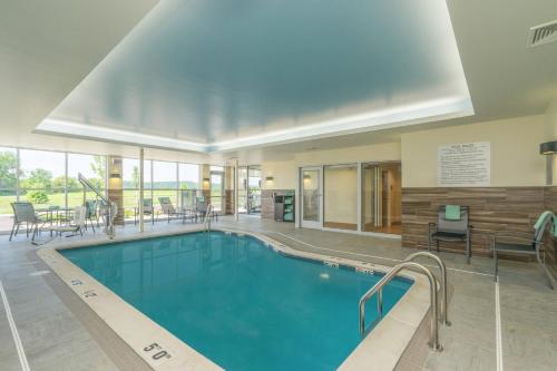 a large swimming pool in a hotel lobby at Fairfield Inn & Suites by Marriott Bloomsburg in Bloomsburg