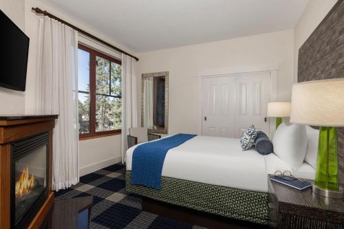 a hotel room with a bed and a fireplace at Marriott Grand Residence Club, Lake Tahoe in South Lake Tahoe