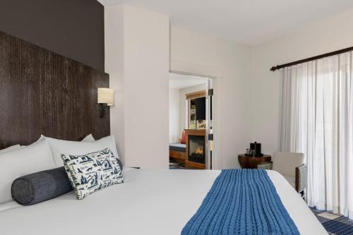 a bedroom with a large bed with a blue blanket at Marriott Grand Residence Club, Lake Tahoe in South Lake Tahoe
