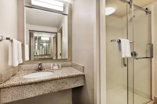 a bathroom with a sink and a shower at Courtyard by Marriott Tulsa Central in Tulsa
