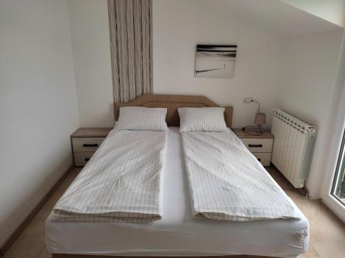 a bedroom with two beds and a window at Apartments Iva in Kotor