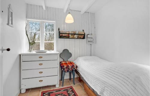 a bedroom with a bed and a dresser and a window at Awesome Home In Bogense With Kitchen in Bogense