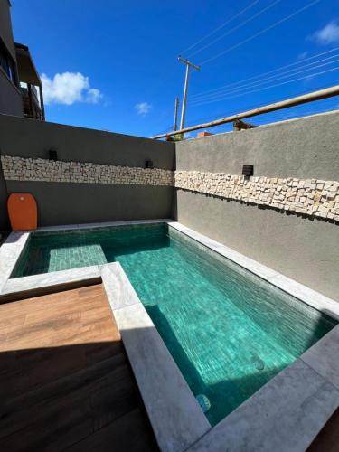 a swimming pool on the roof of a building at Casa Tulum em São Miguel dos milagres in São Miguel dos Milagres