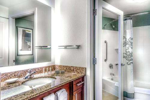 La salle de bains est pourvue d'un lavabo et d'une douche. dans l'établissement Residence Inn Arlington Courthouse, à Arlington
