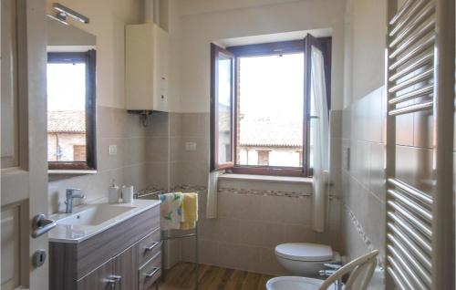 a bathroom with a sink and a toilet and a window at Stunning Home In Dignano With Wifi And 2 Bedrooms in Taverne