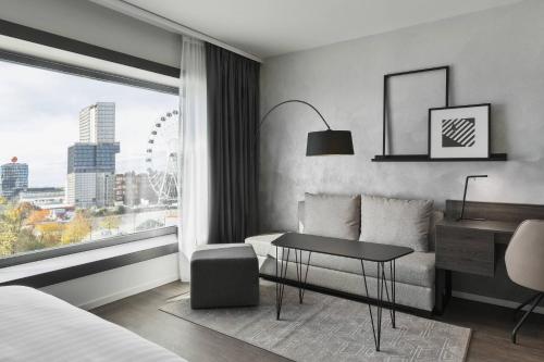 a hotel room with a bed and a desk and a window at Residence Inn by Marriott Munich Ostbahnhof in Munich