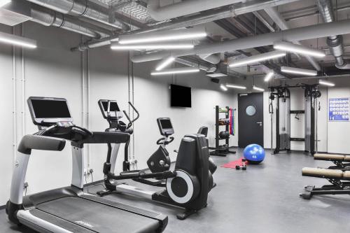 a gym with treadmills elliptical machines and weights at Residence Inn by Marriott Munich Ostbahnhof in Munich