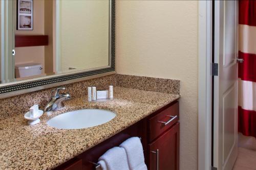 a bathroom with a sink and a mirror at Residence Inn by Marriott Covington Northshore in Covington