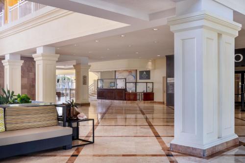 a lobby of a building with white columns at Marriott St. Kitts Beach Club in Frigate Bay