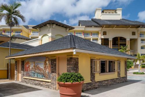 a yellow house with a black roof at Marriott St. Kitts Beach Club in Frigate Bay