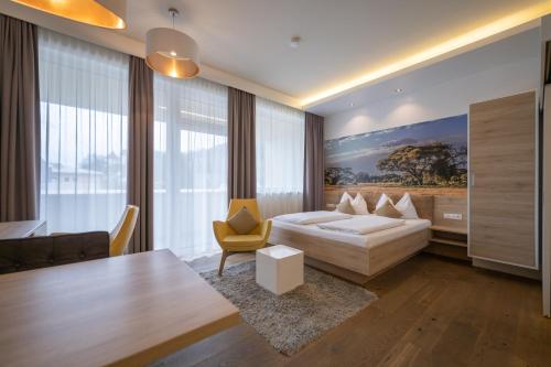 a bedroom with a bed and a table and a couch at PM-PremiumAPART Strassgang in Graz