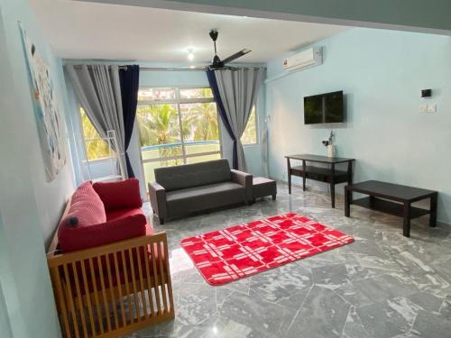 a living room with a couch and a table at Mr Singh Homestay in Kampong Tanah Merah