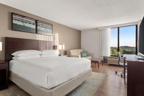 a bedroom with a large white bed and a desk at Delta Hotels by Marriott Bristol in Bristol