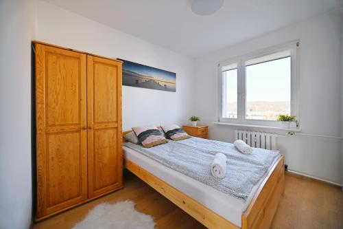 a bedroom with a bed and a large window at Horyzont by 3City Rentals in Gdynia