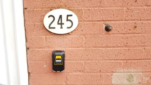 a sign on a brick wall with the number twentyfive at Cudworth House, Barnsley for contractors & Families, off-road parking, speedy WIFI,etc in Barnsley