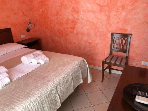 a bedroom with a bed and a chair and a desk at L’attico Piazza Sant’Oronzo in Lecce