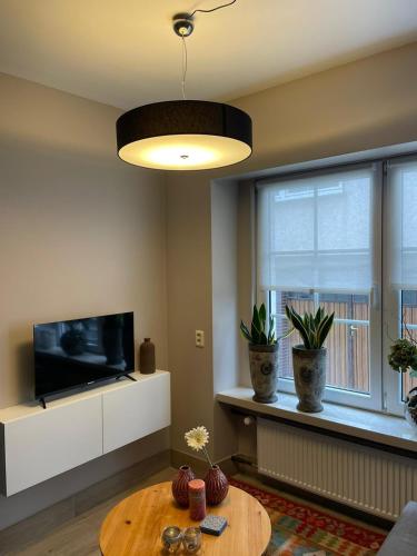 a living room with a coffee table and a television at Excellent house in Ediger-Eller