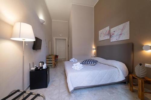 Postel nebo postele na pokoji v ubytování GreRos H. Rooms Napoli Centro by Clapa Group Dislocated Hospitality