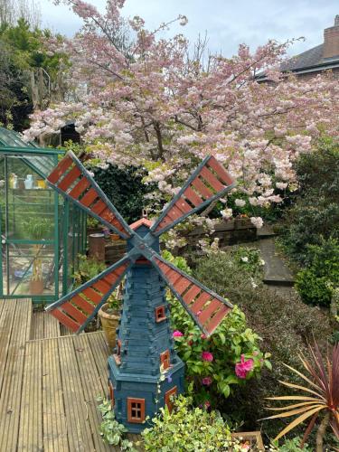 a model of a windmill in a garden at Bumble Bee Cottage in Plymouth