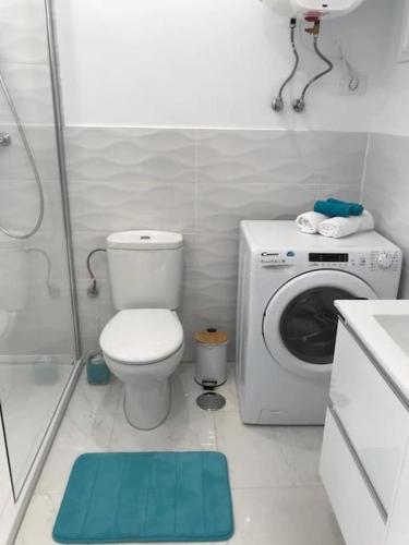 a bathroom with a toilet and a washing machine at Costa Adeje Modern Studio, close to the beach in Adeje