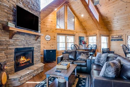 a living room with a fireplace in a log cabin at Blue Ridge Bear Bungalow in Blue Ridge