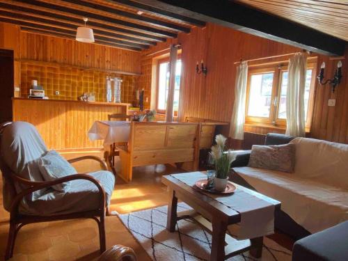 a living room with a couch and a table at Appartement chalets T2 50m2 in Publier