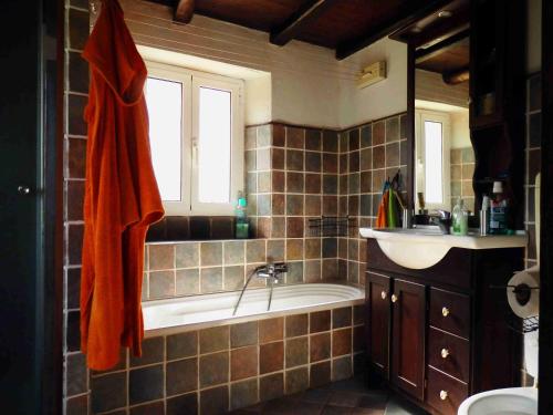 a bathroom with a bath tub and a sink at @gatetothewild in Coreglia Ligure