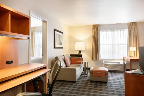 a hotel room with a couch and a living room at TownePlace Suites Gaithersburg in Gaithersburg