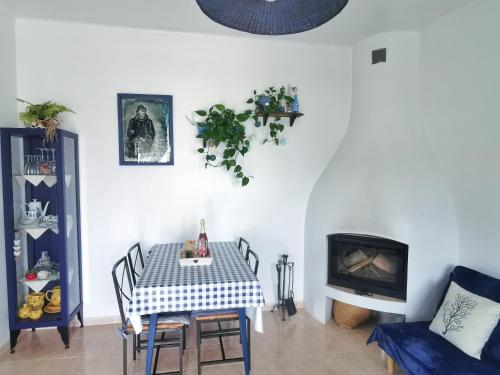 a dining room with a table and a chair at Caseta de pescadors a les cales de Colera, 2ª linea de mar in Colera