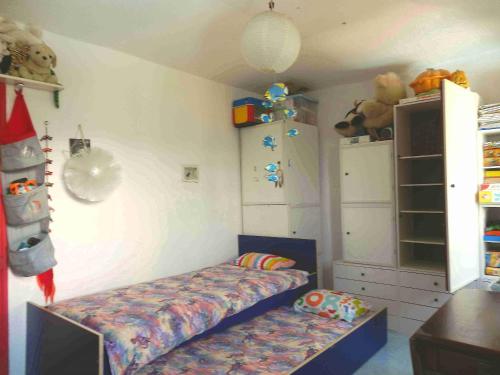 a small bedroom with a bed and a shelf at @gatetothewild in Coreglia Ligure