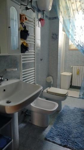 a bathroom with a white sink and a toilet at Il Trullo di Nonno Angelo San Marco in Locorotondo