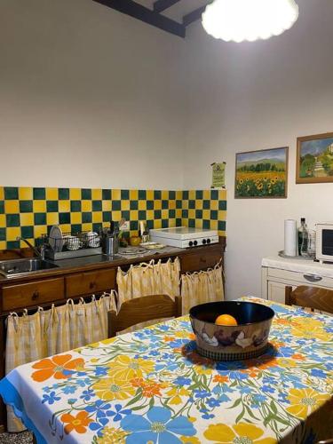 a kitchen with a table with a bowl of oranges on it at Da Nonna Bruna in Montalcino