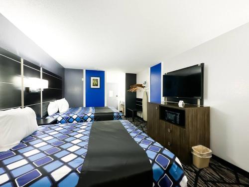 a hotel room with a bed and a flat screen tv at Blaine Town Inn & Suites in Blaine