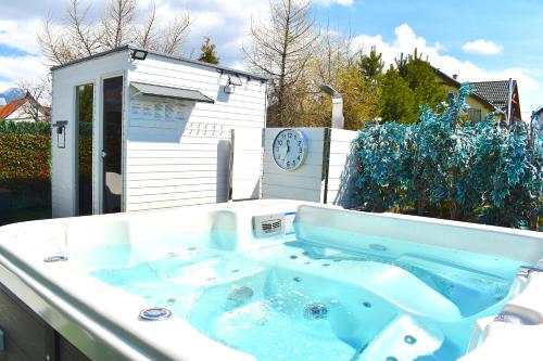 a jacuzzi tub in a yard with a house at Serenity in Pribylina