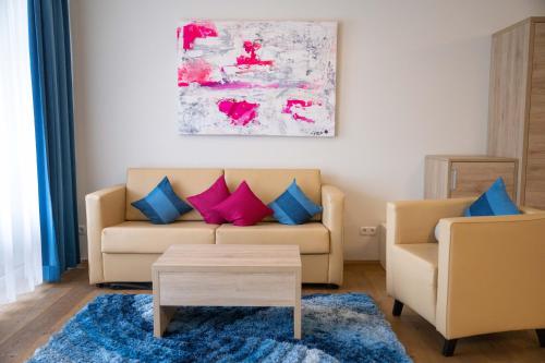 a living room with a couch and two chairs at PM-PremiumAPART Strassgang in Graz
