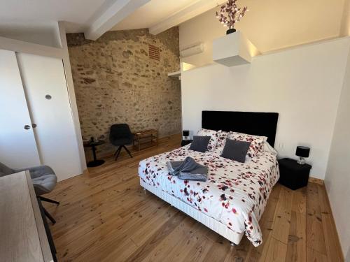 a bedroom with a bed with a comforter on it at BOCAL DE BAGES in Bages