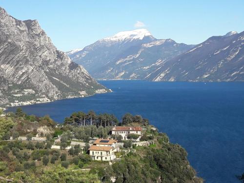 a house on a hill in front of a body of water at Casa Bine in Tremosine Sul Garda