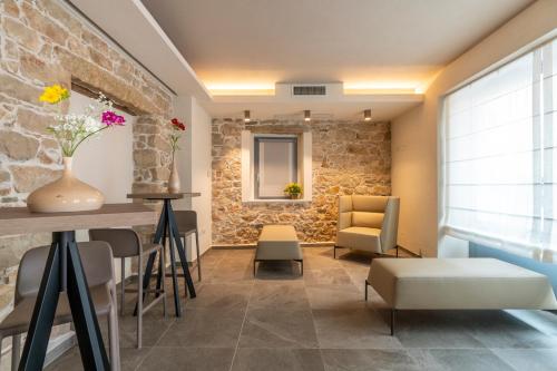 a living room with a stone wall at Goloritzè Room and Breakfast in Baunei