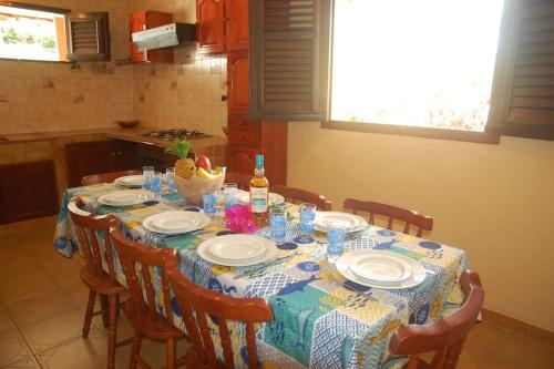 a dining room table with plates and drinks on it at Maison familliale Saint Pierre in Sainte-Luce