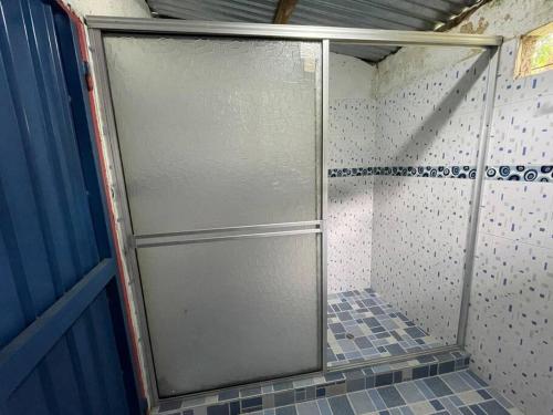 a shower stall with a sliding glass door in a bathroom at Cabaña con vista al Río in Ibagué