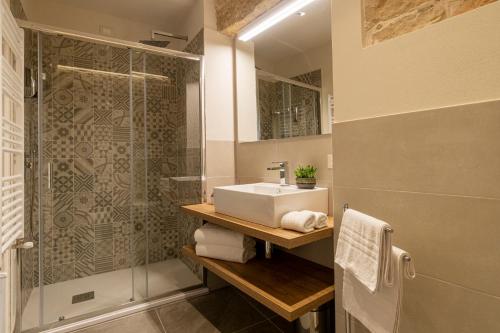 a bathroom with a sink and a shower at Goloritzè Room and Breakfast in Baunei