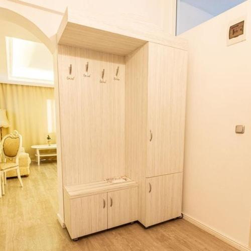 a large wooden cabinet in the corner of a room at Grand Hotel Baroc in Zalău