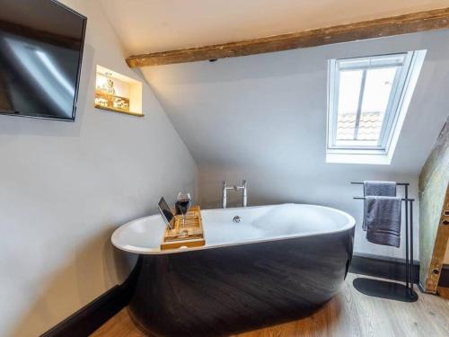 a large bath tub in a bathroom with a window at One Over Eight in Whitby