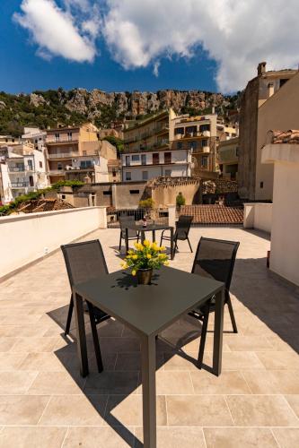 a table and chairs on the roof of a building at Goloritzè Room and Breakfast in Baunei