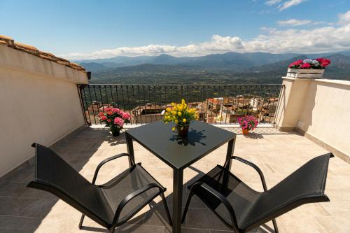 a table and chairs on a balcony with a view at Goloritzè Room and Breakfast in Baunei