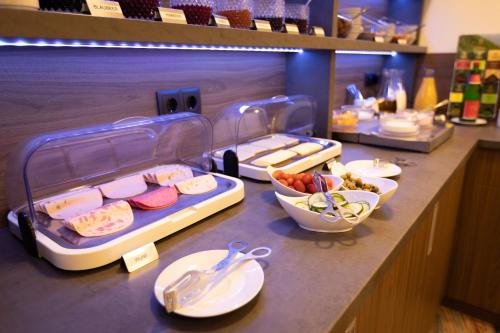 a buffet line with different types of food on at Firzlaff's Hotel in Neumünster
