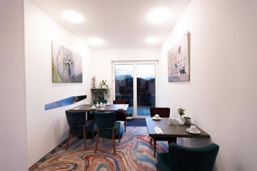 a dining room with two tables and chairs at Firzlaff's Hotel in Neumünster