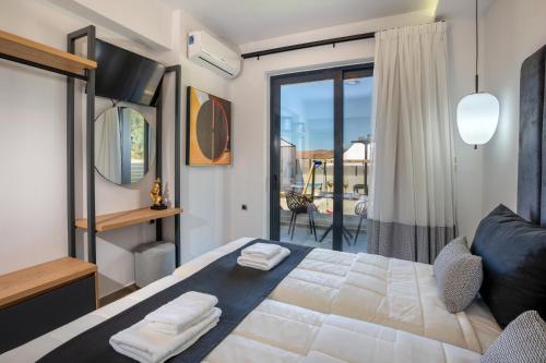 a bedroom with a large bed and a balcony at Luxurious villa Micha Mare - 14 Bedrooms in Roumelí