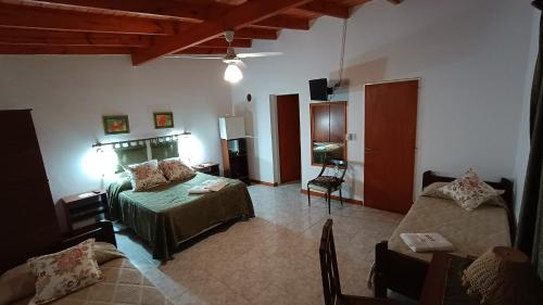 a living room with a bed and a couch at Castelar - Hotel & Apart in Huerta Grande