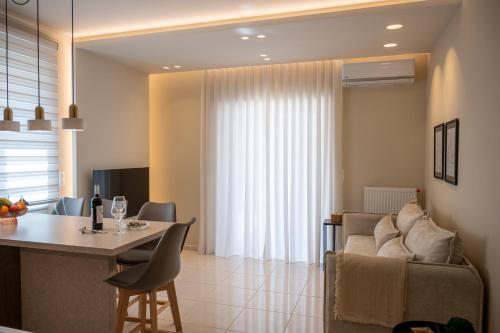 uma cozinha e sala de estar com um sofá e uma mesa em Konstantina's Luxury Apartment em Nafplio